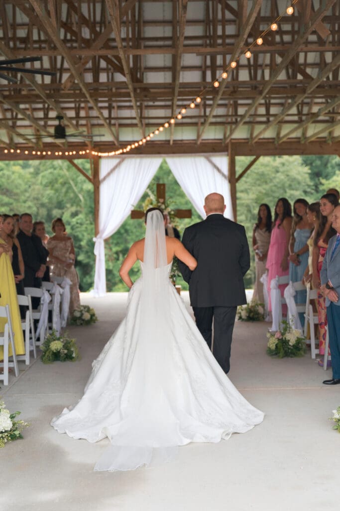 A bride being walked down the aisle by her father