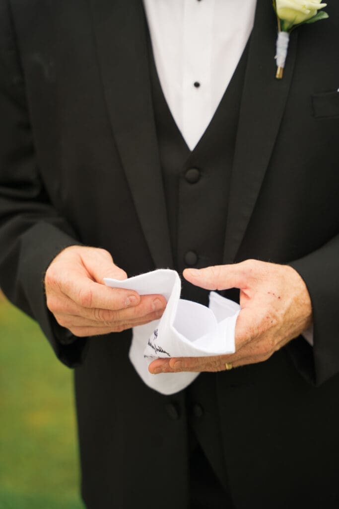 The father of the bride holding a handkerchief 
