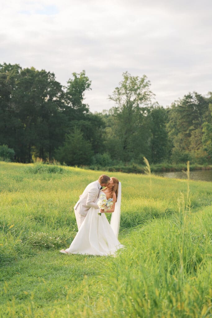 Bride and groom kissing surrounded by nature