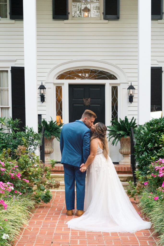 a couple kissing on their wedding day in front of flint hill