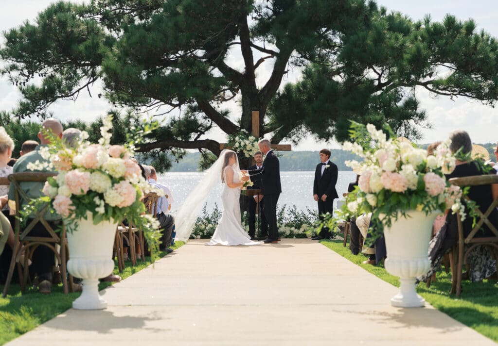 The father of the bride handing his daughter off to the groom for them to wed