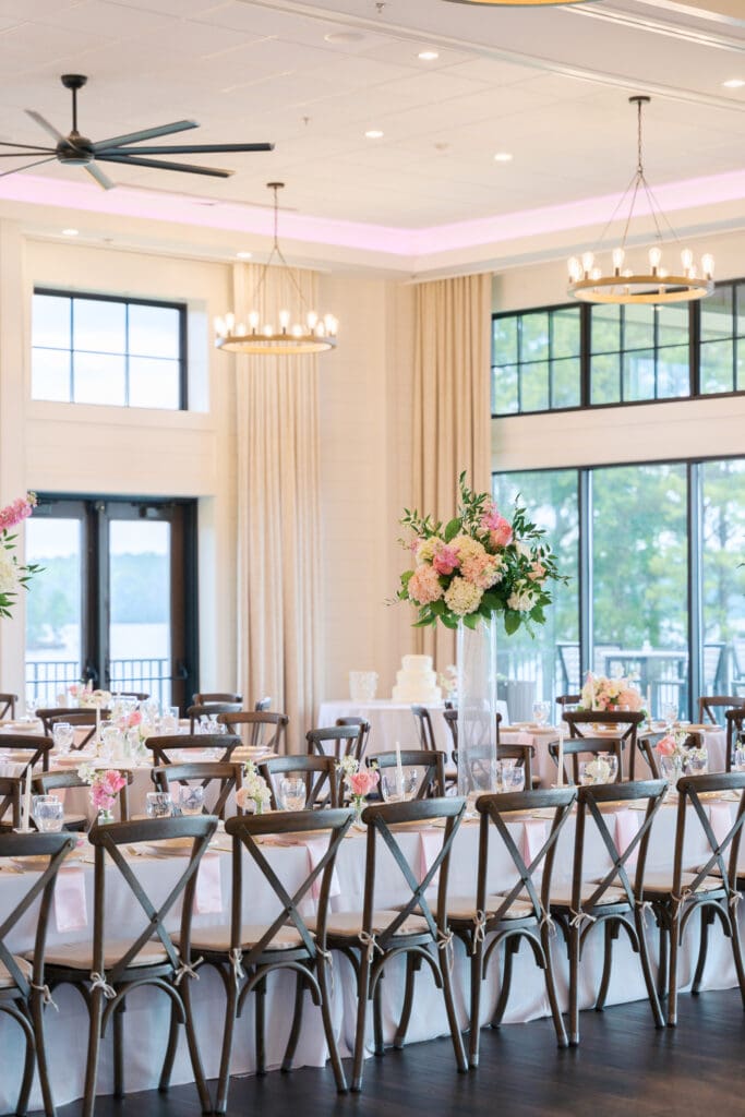 a long table decorated in pink florals on a wedding day