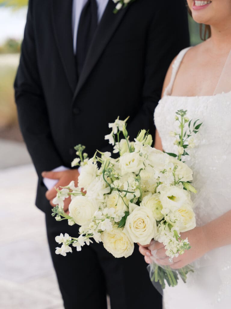 a bride holding her bouquet of ivory and cream florals