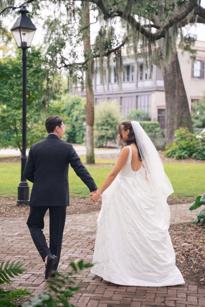 a groom leading his bride on a walk